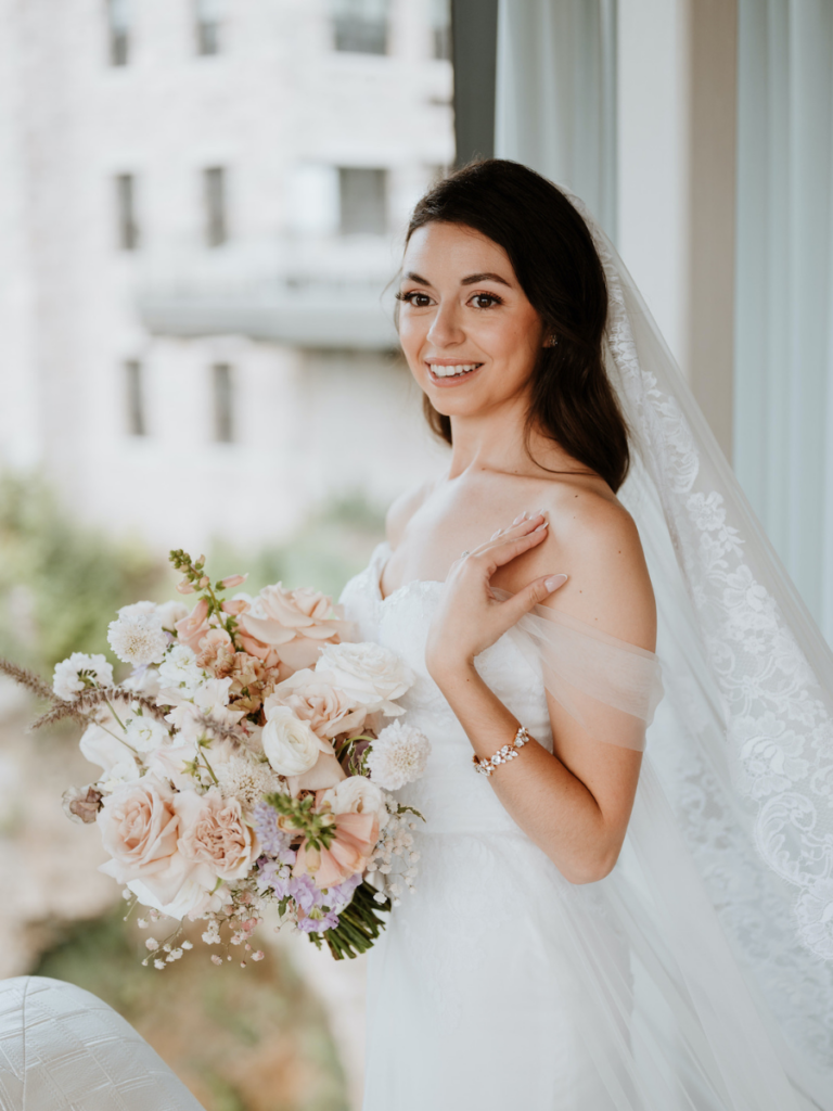 Bride with bouquet at Elora Mill