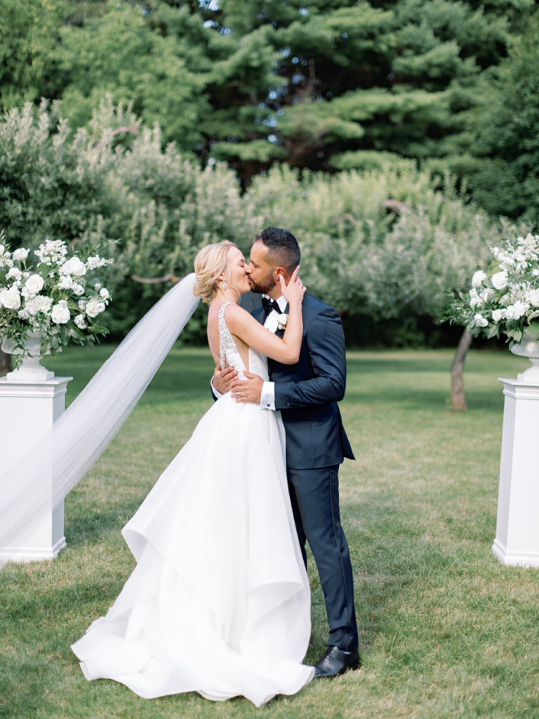 Bride and Groom sharing their first kiss as newlyweds at their modern Langdon Hall wedding