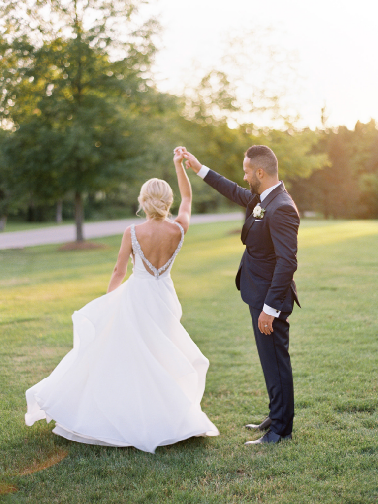 Bride and groom dancing on Langdon Hall's ground during golden hour