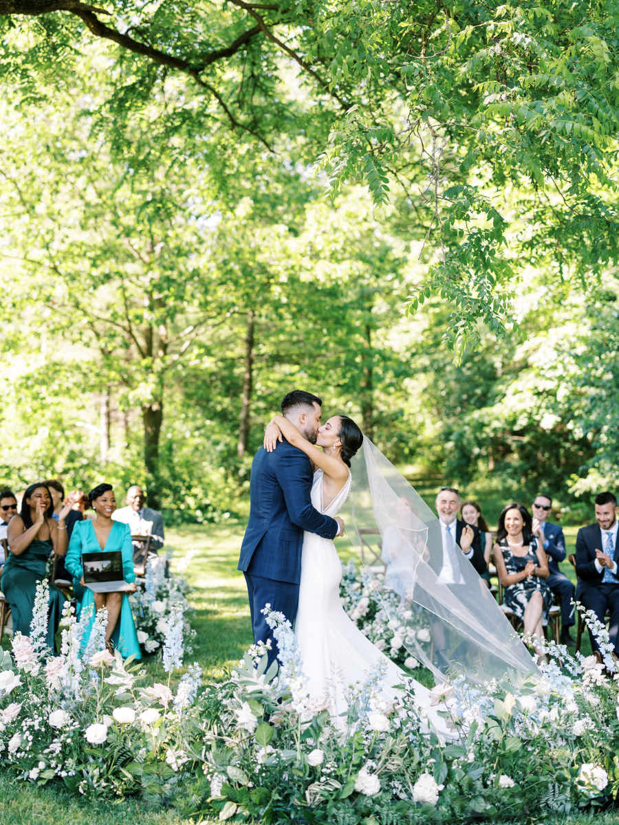 The bride and groom sharing their first kiss as newlyweds at their Langdon Hall wedding