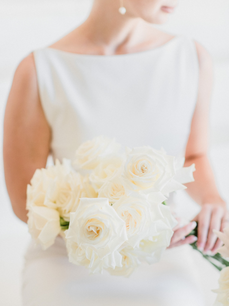 Bridal bouquet filled with white long stemmed roses