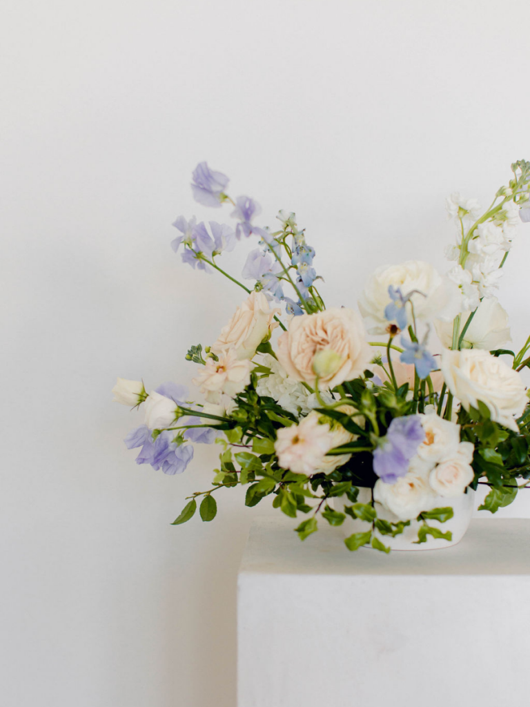 Detailed shot of blush centerpiece with accents of purple and blue florals