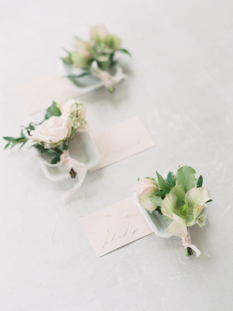 Detailed shot of the boutonnieres with name tags
