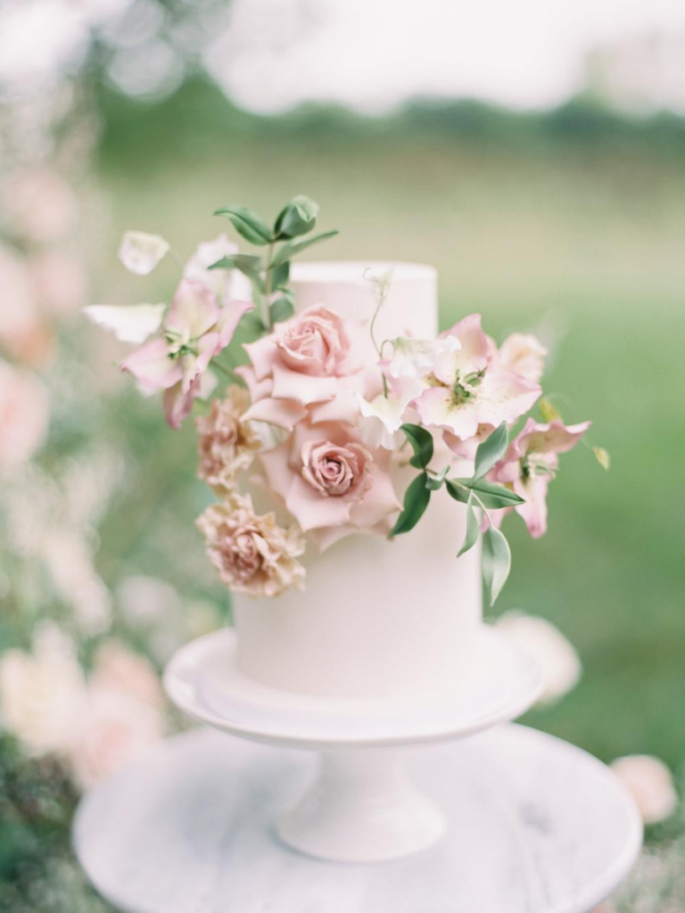 White wedding cake with flowers on it