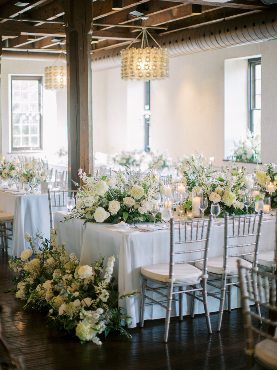 The Governor's Room at the Ancaster Mill filled with classic white and green floral arrangements 