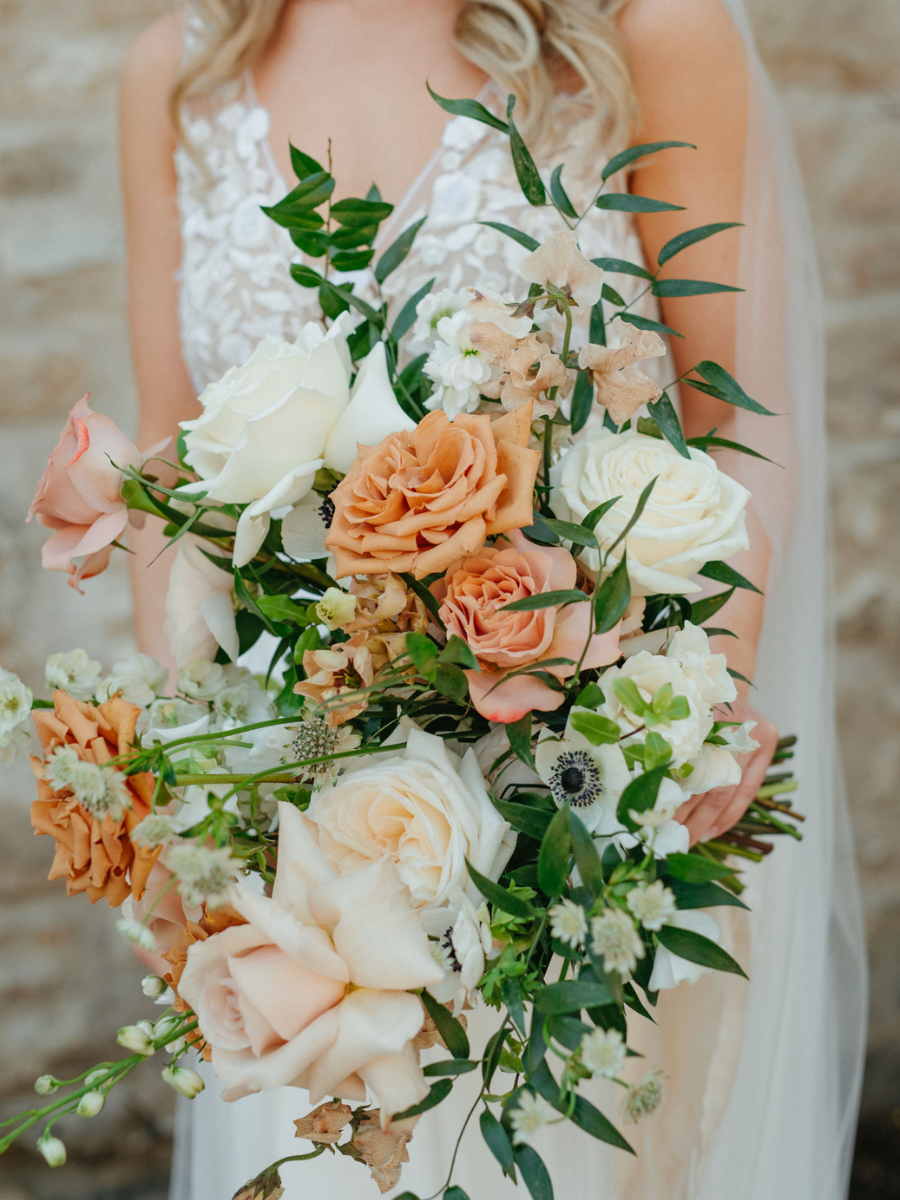 Romantic bridal bouquet filled with quicksand roses, toffee roses, cappuccino roses, anemones, brownie sweet pea and mocha lisianthus