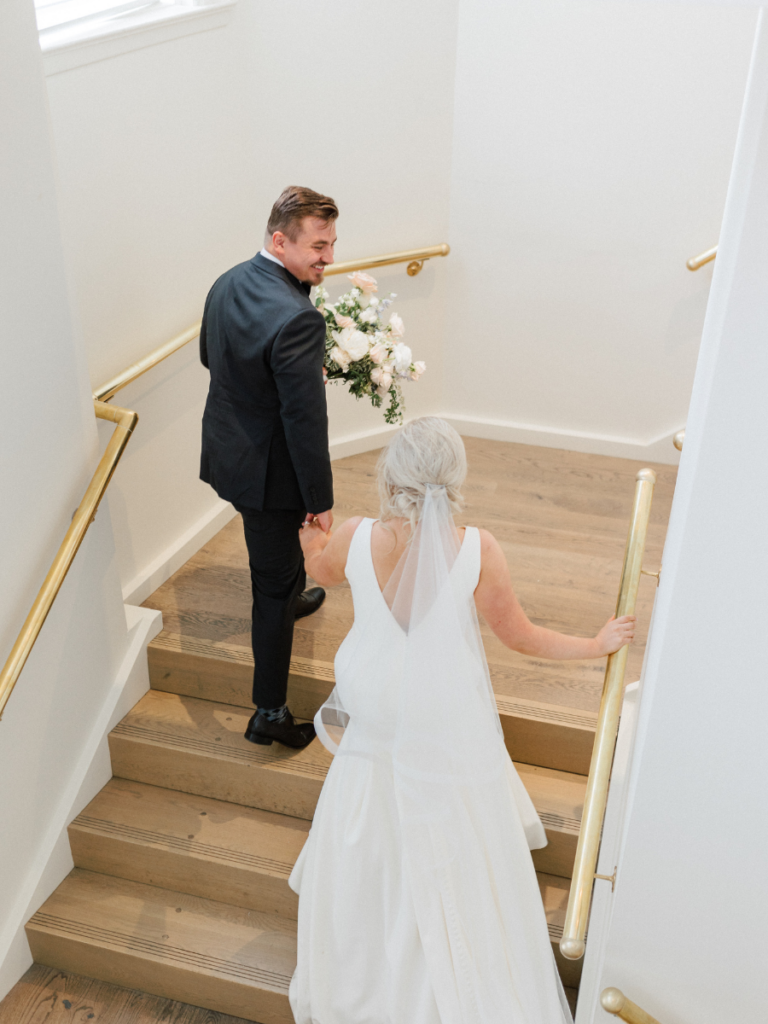 Bride and groom walking up to their reception at The Walper Hotel