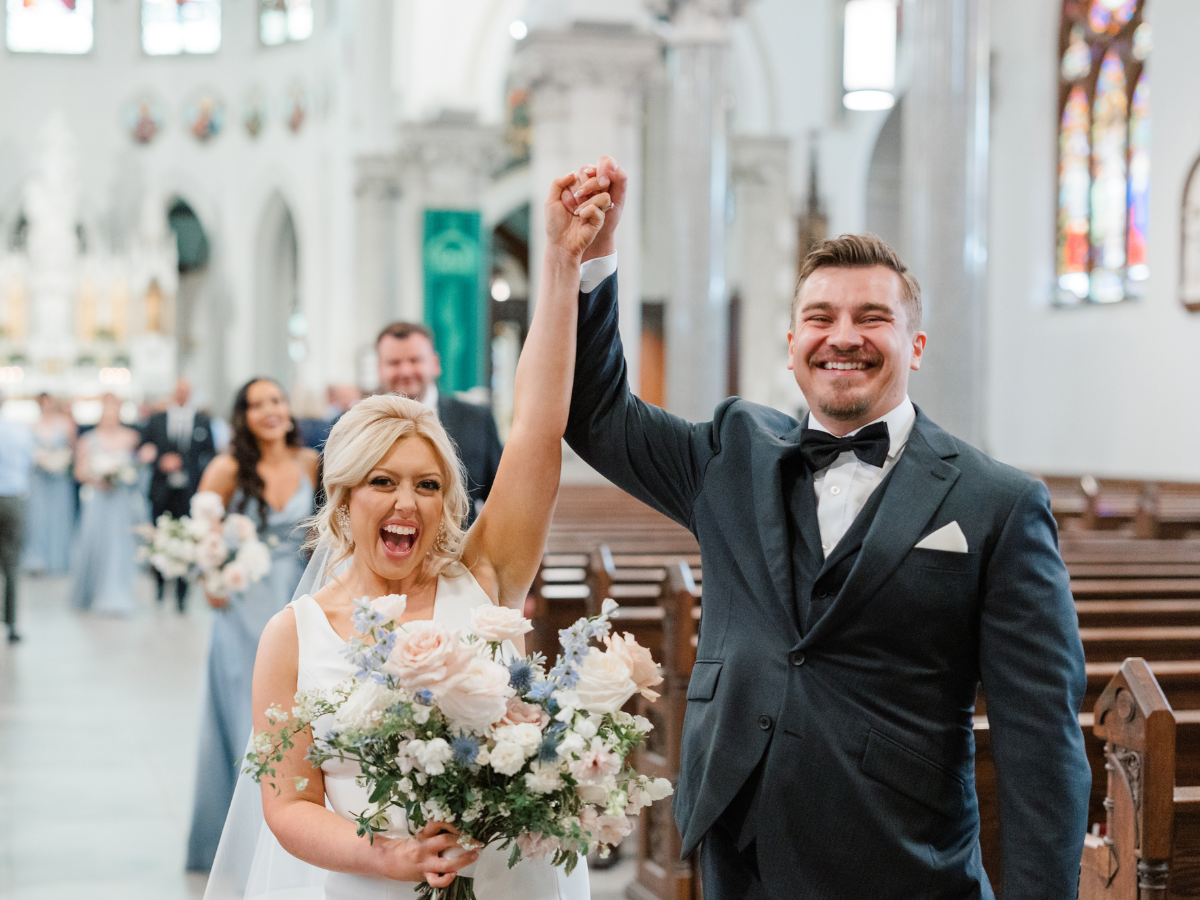 Bride and Groom Celebrating at the end of the aisle at the Basilica of Our Lady Immaculate in Guelph 